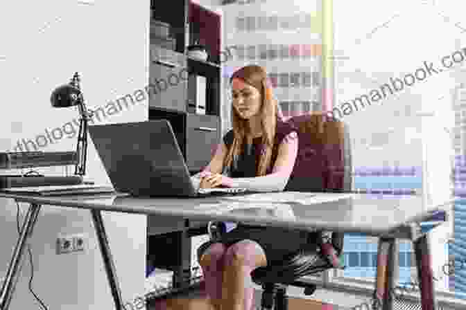 A Woman Sitting At A Desk, Working On A Computer. Women And Transition: Reinventing Work And Life
